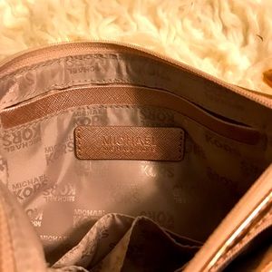 MK clutch purse with tiny strap.